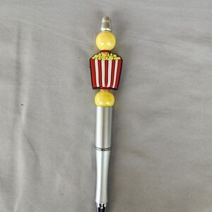 Silver beadable pen with a silicone BUCKET OF BUTTERY POPCORN focal bead